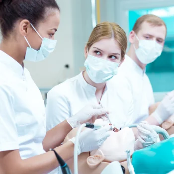 dental nurses training dentistry on a dummy
