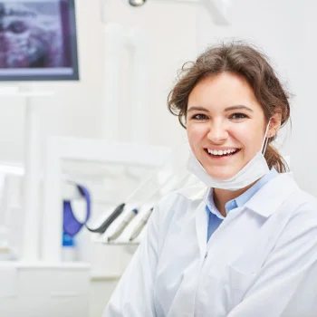 young female dental assistant smiling in a clinic