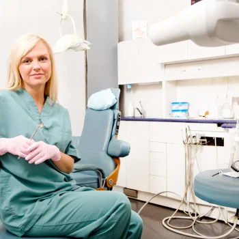 trainee dental nurse sitting in a chair in a clinic